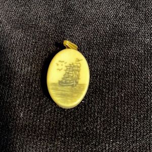 Scrimshaw-like pendant.